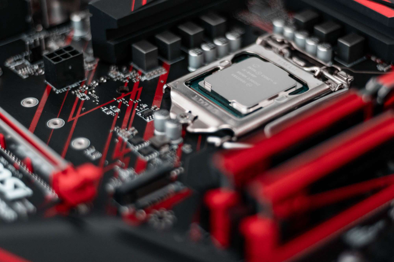 Image of black and red motherboard with inserted CPU